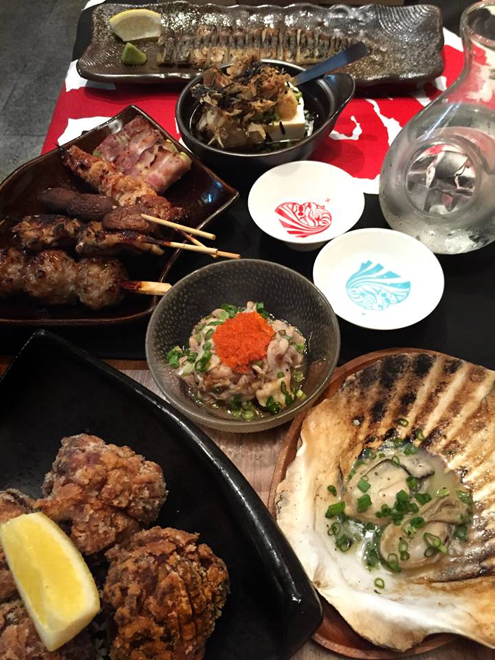 japanese food at shukuu izakaya paired with sake - sake bottles and bowl - candybar merchant stories