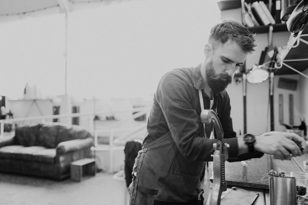 leatherworker crafting in his workshop