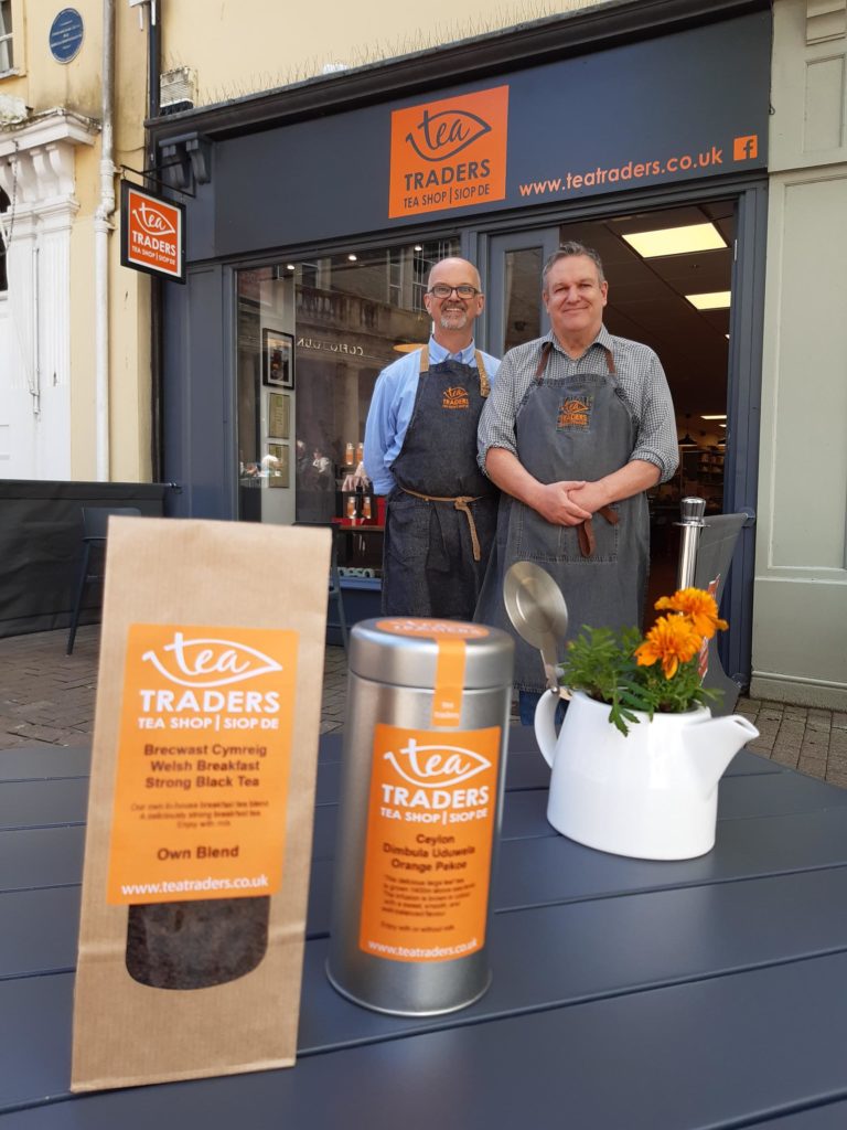 Paul and his partner, Nick, in front of their store, Tea Traders, in Carmarthen, Wales